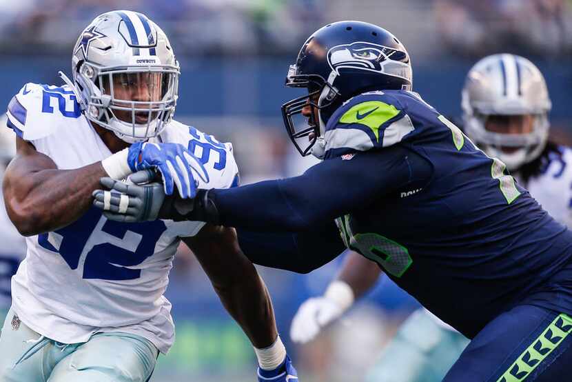 SEATTLE, WA - SEPTEMBER 23:  Defensive End Dorance Armstrong #92 of the Dallas Cowboys tries...