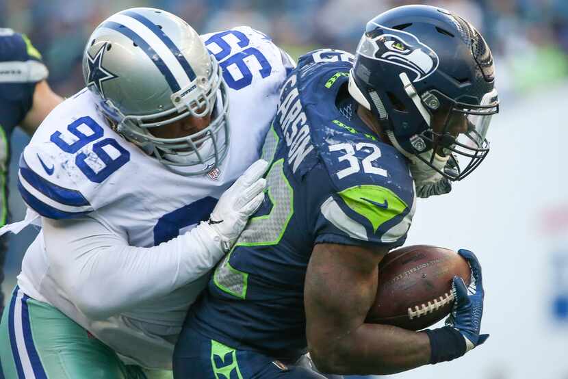 FILE - Dallas Cowboys nose tackle Antwaun Woods (99) tackles Seattle Seahawks running back...