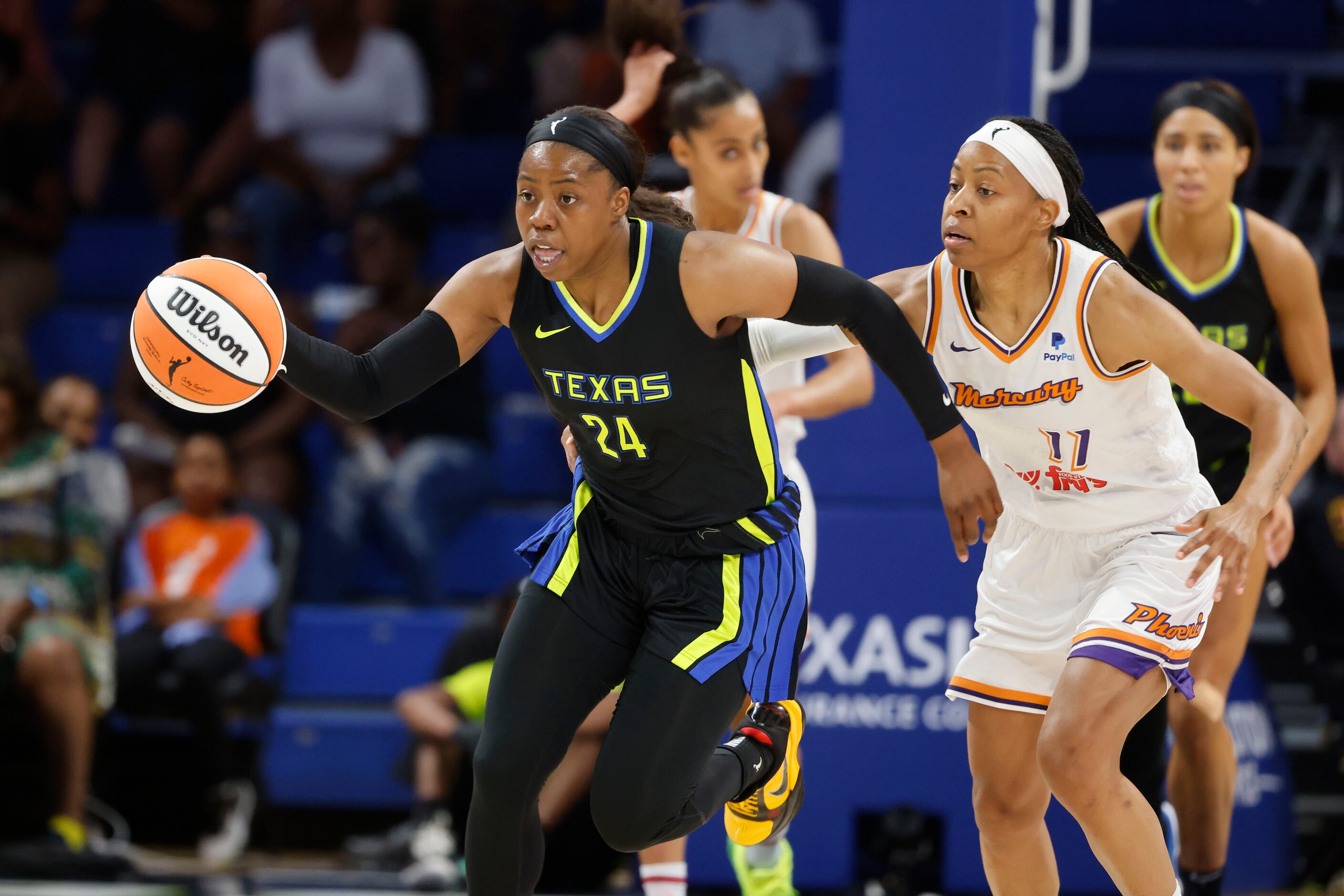 Dallas Wings guard Arike Ogunbowale (24) moves the ball up the court against Phoenix Mercury...