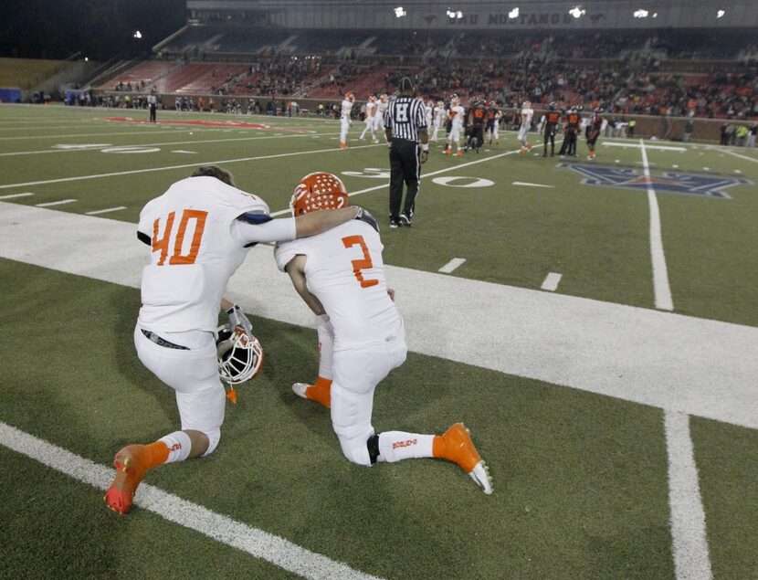 Celina player Austin Geiger (40 and  Dalton Ferry (2) share a moment as time runs out as...