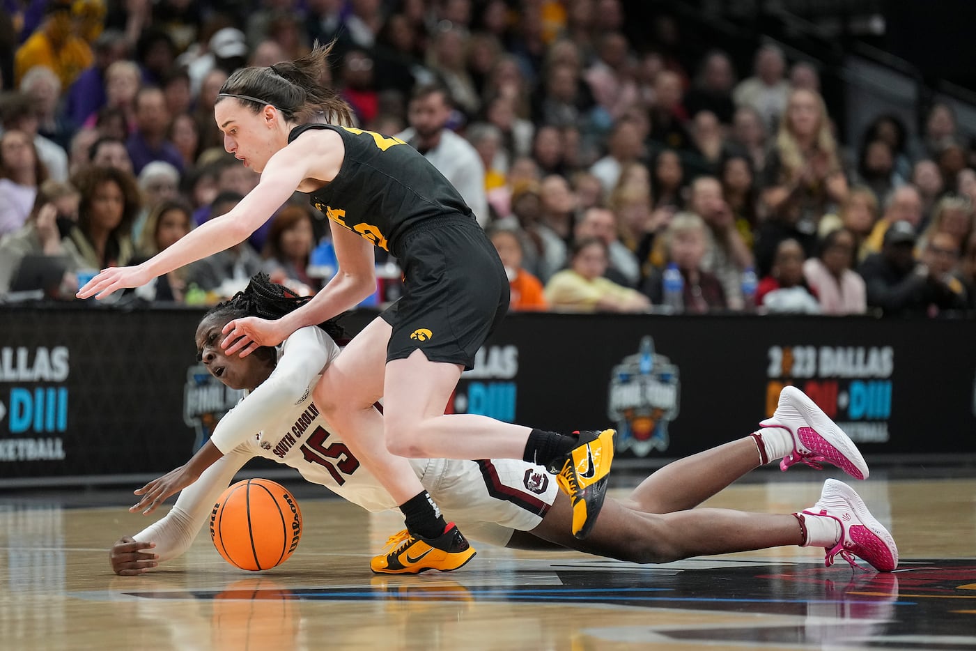 Iowa guard Caitlin Clark (22) scrambles for a loose ball against South Carolina forward...