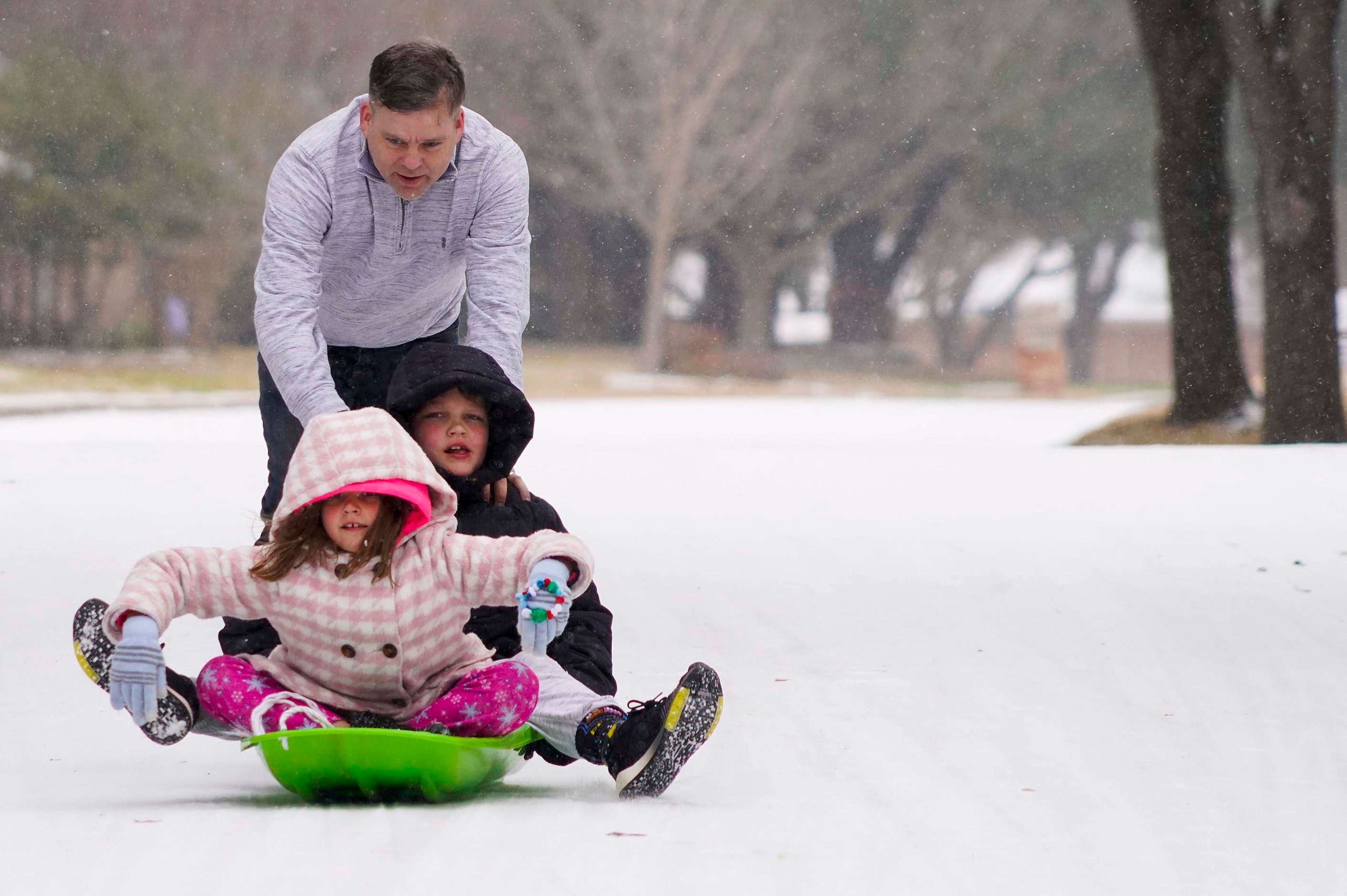 Mae, 9, and Vaughn, 11, Scrogginthorpe get a push from their dad Micah Scrogginthorpe they...