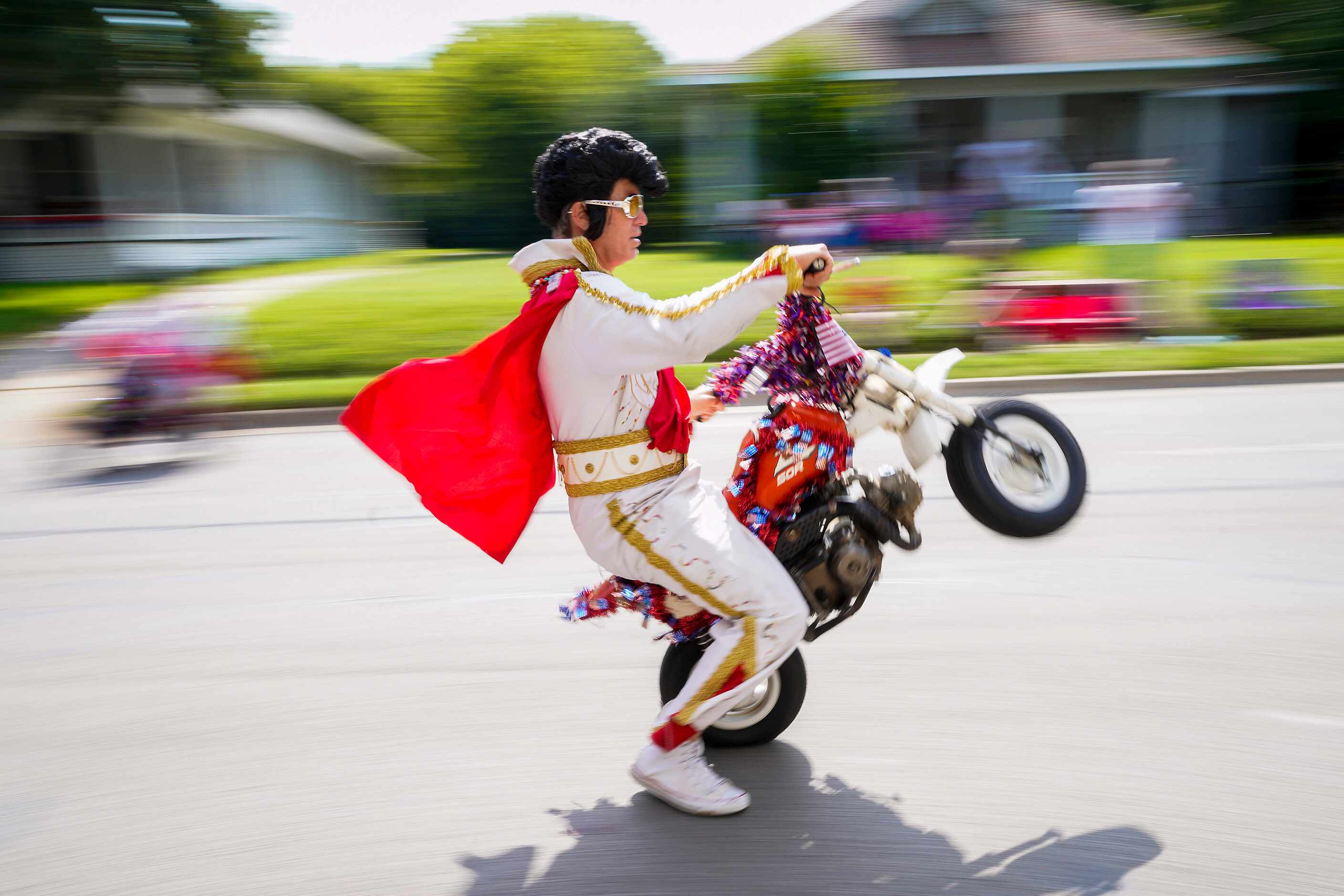 Members of the The World Famous Wheelie-ing Elvi ride in the Arlington Independence Day...