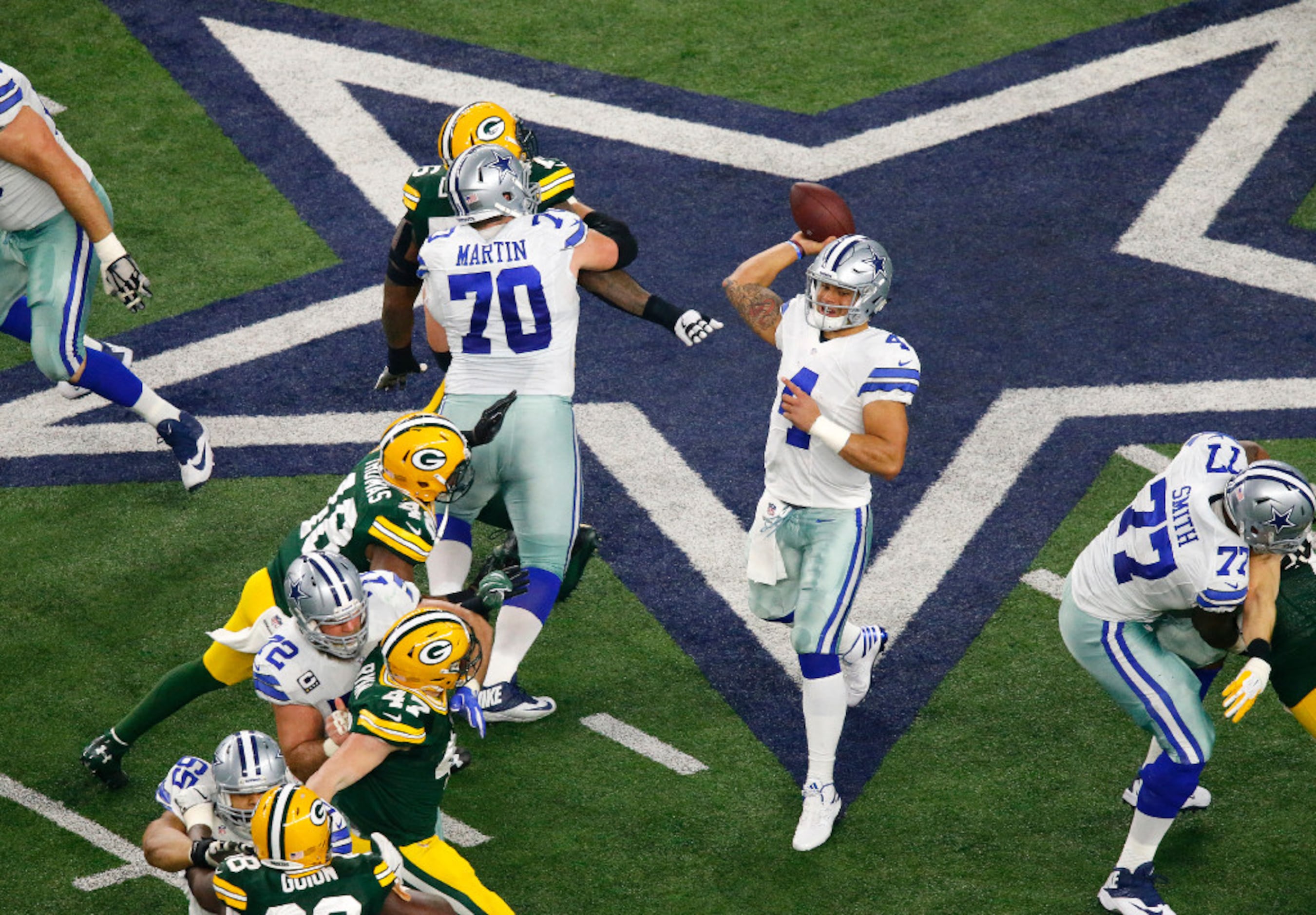 Green Bay Packers Aaron Rodgers looks to throw against the Dallas Cowboys  in the NFC divisional playoff game at AT&T Stadium in Arlington, Texas on  January 15, 2017. Rodgers went 28 of