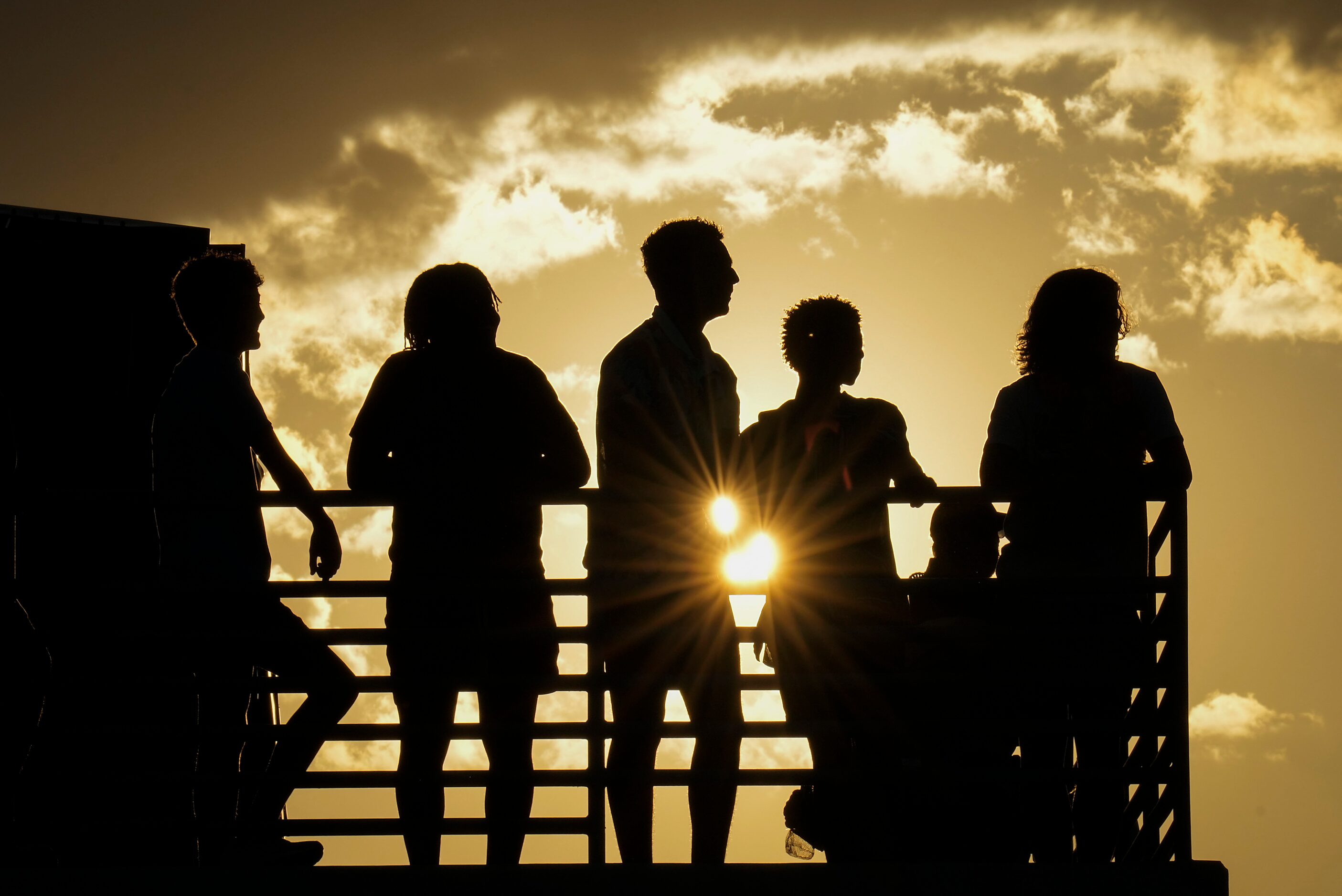 Denton Guyer fans watch as the sun sets during the first half of a high school football game...