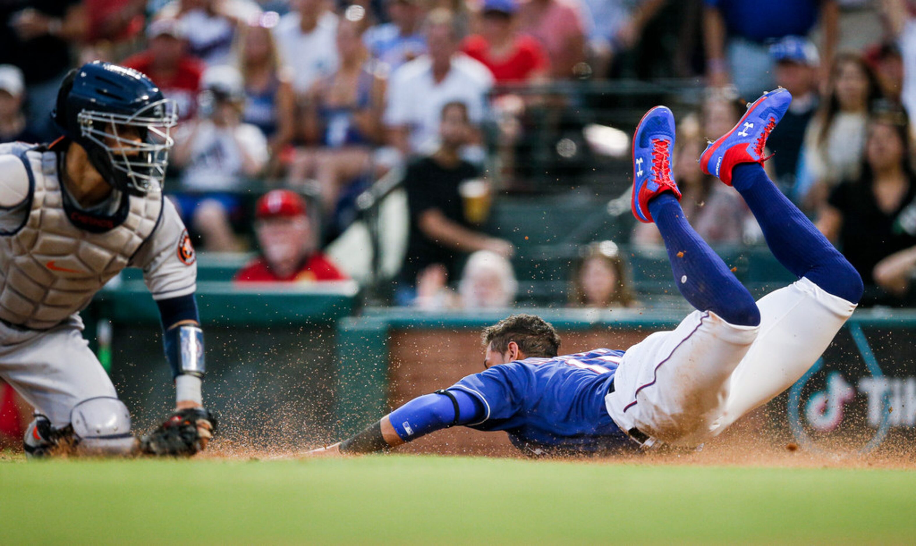 Houston Astros catcher Robinson Chirinos, left, is unable to make the tag as Texas Rangers'...