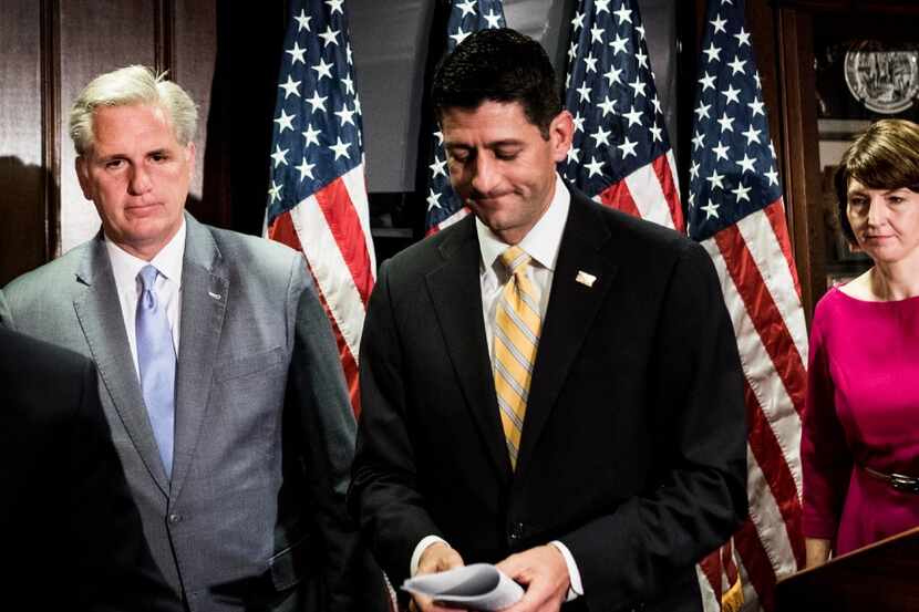 Speaker of the House Paul Ryan (center) and House Majority Leader Kevin McCarthy talk to the...