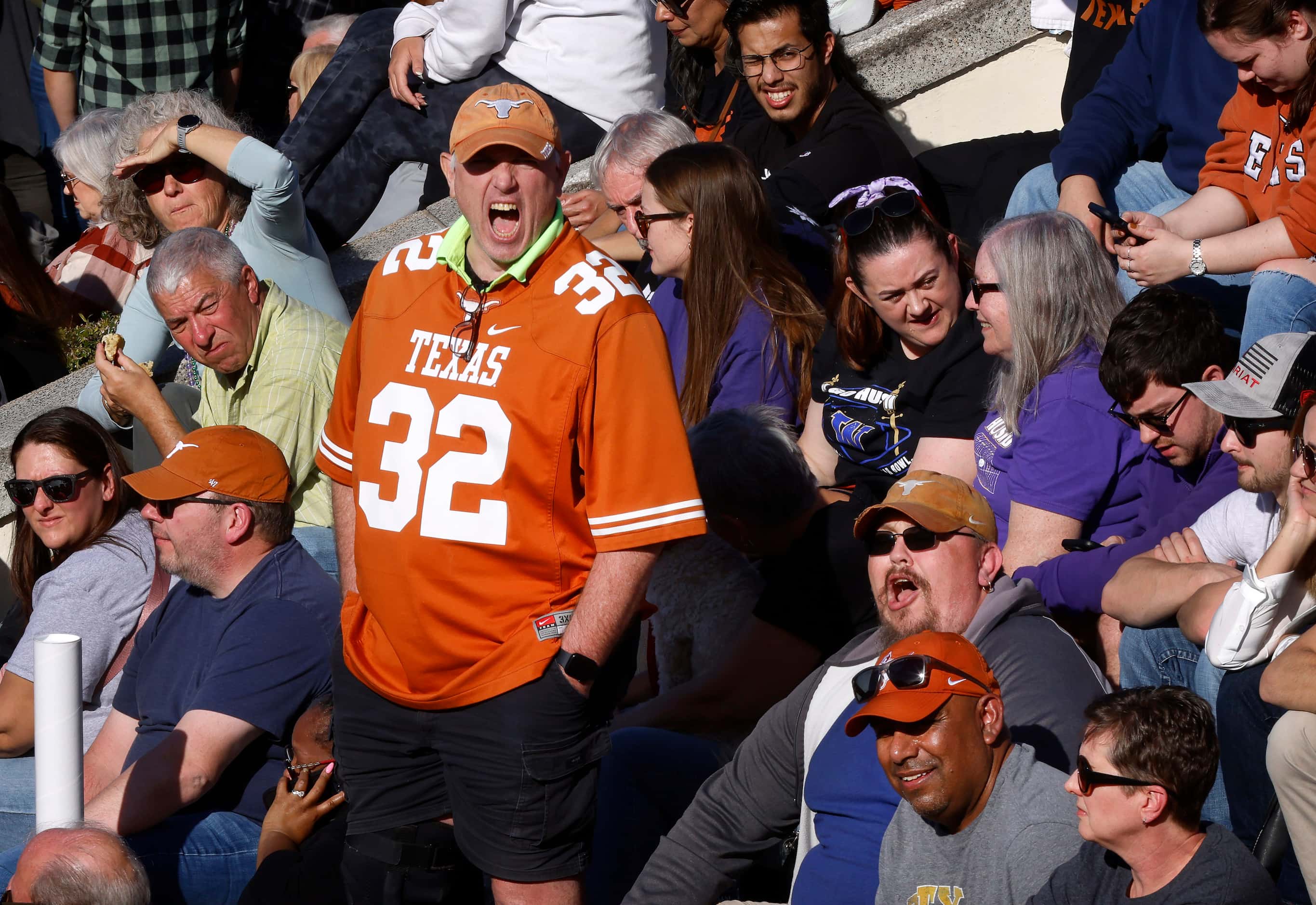 A Texas Longhorns fan starts a ‘Texas!, Fight!’ chant before the Mardi Gras-style Allstate...