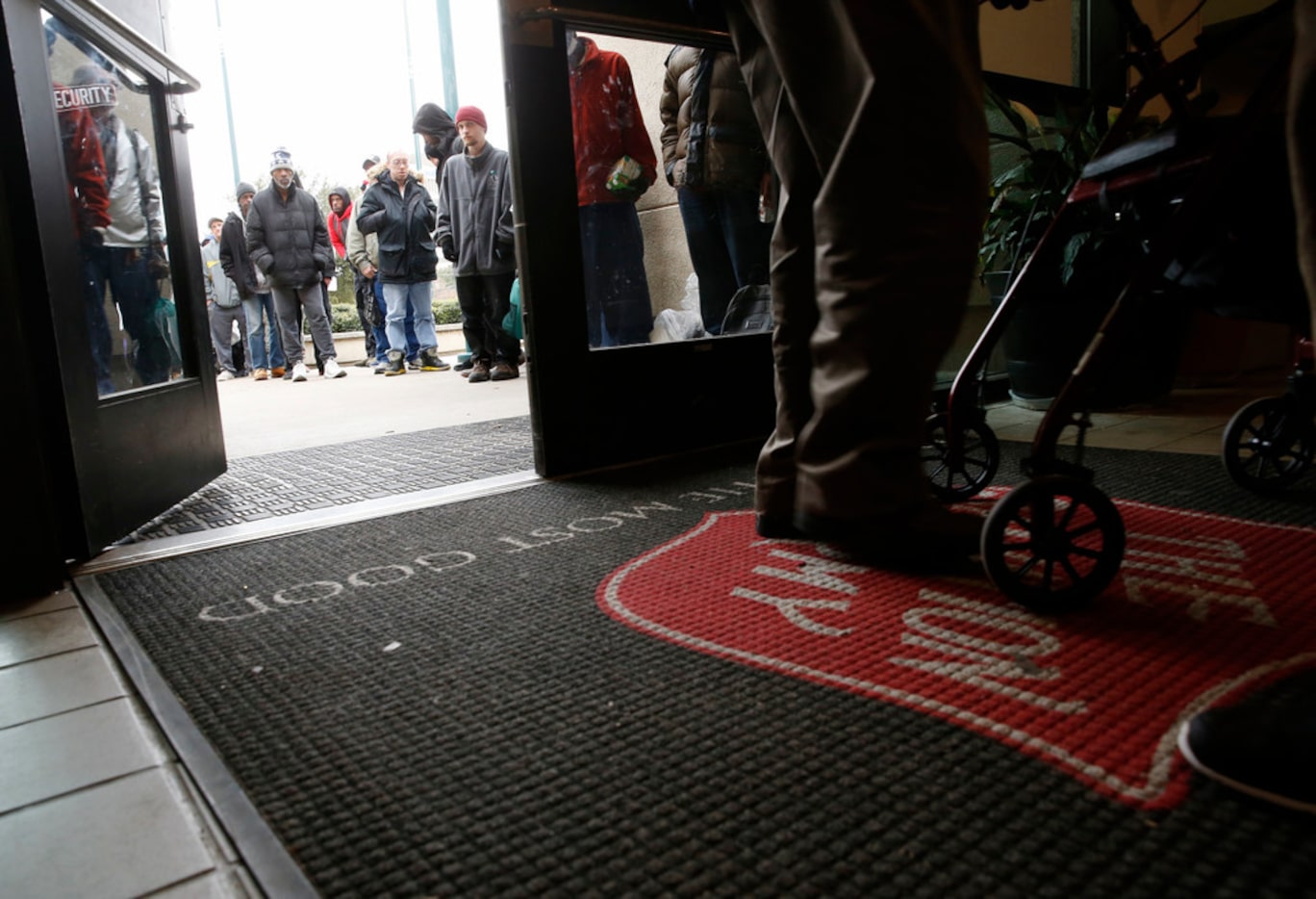 People wait in line Feb. 8 to check in for a bed at the Carr P. Collins Social Service...