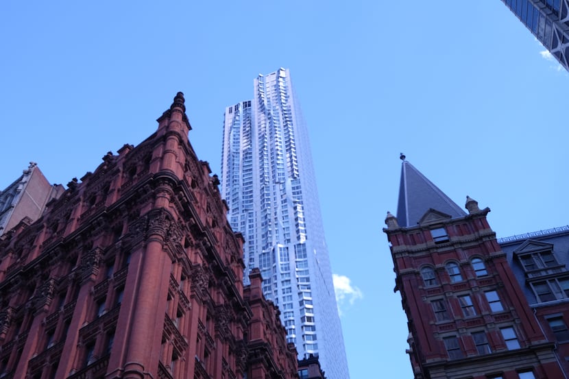A new Frank Gehry condo tower design contrasts with a pair of older buildings in Lower...