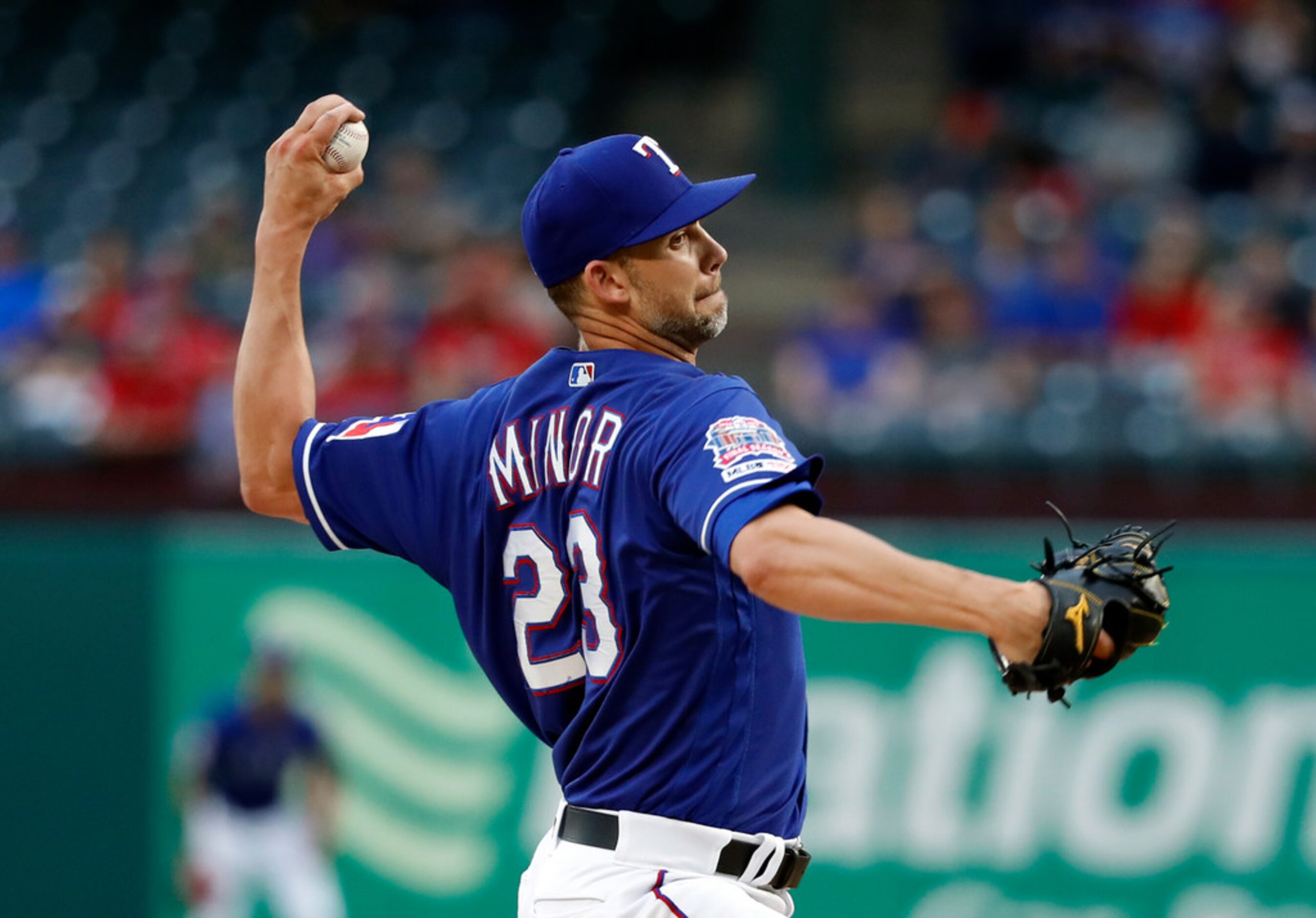 Texas Rangers starting pitcher Mike Minor throws to a Los Angeles Angels batter during the...