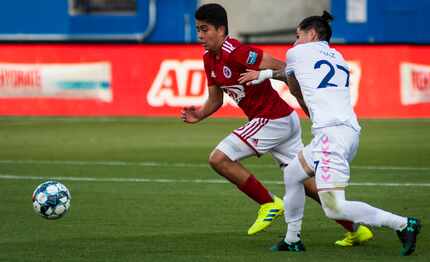 David Rodriguez (8) duels with Madison defender Christian Diaz (27).