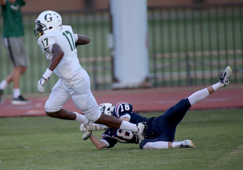 Fort Worth Country Day's Turner Symonds, 18, misses a shoe string tackle of Greenhill...