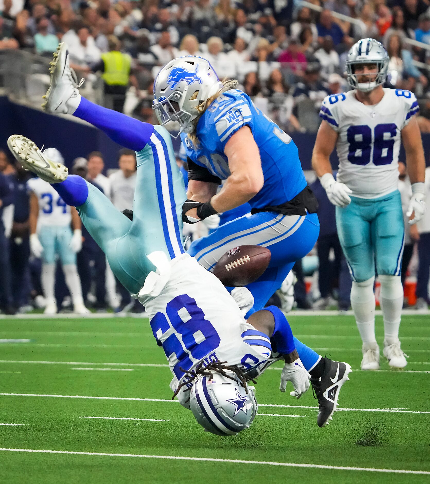 Dallas Cowboys wide receiver Noah Brown (85) fumbles as he is flipped upside down while...