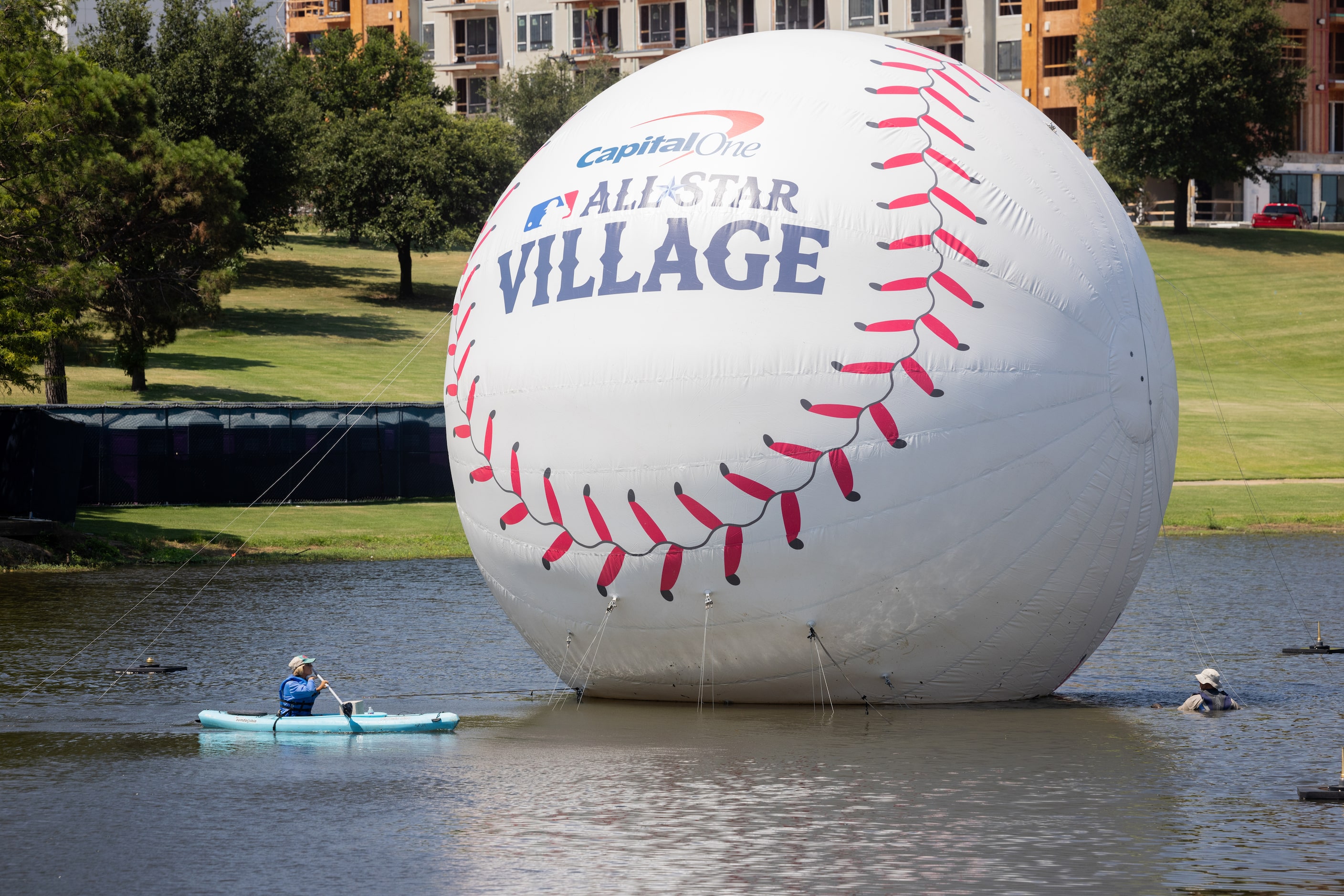 A floating baseball on display on Mark Holtz Lake at MLB's All-Star Village in Arlington on...