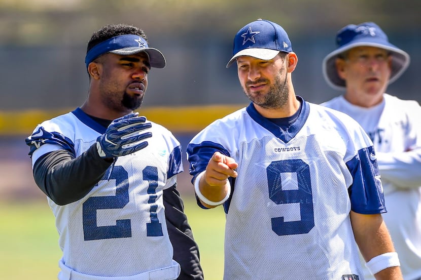 Dallas Cowboys running back Ezekiel Elliott (21) and teammate quarterback Tony Romo (9) talk...