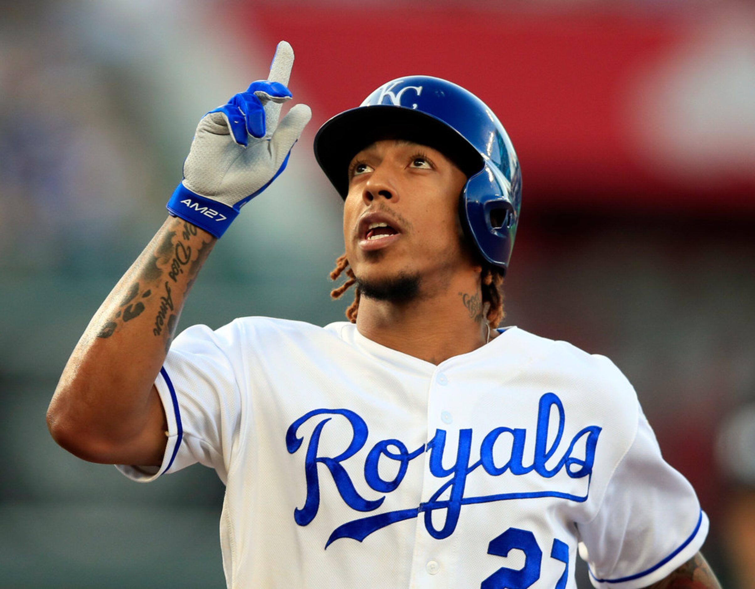 Kansas City Royals' Adalberto Mondesi gestures after his RBI single during the first inning...