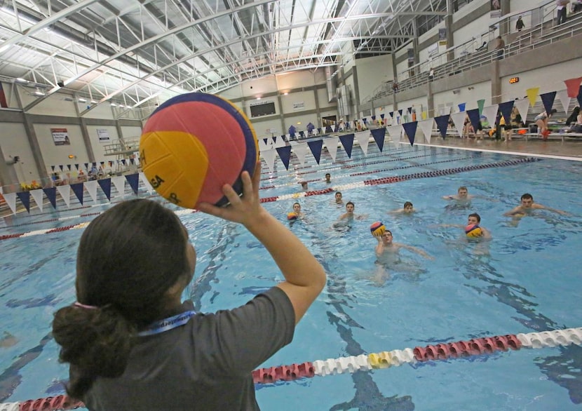 
Coach Angela Uno works with the HSAA boys team during practice at Rockwall ISD Aquatic...