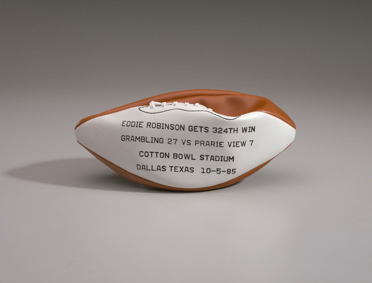 A football was printed with details about Grambling State coach Eddie Robinson's 1985...