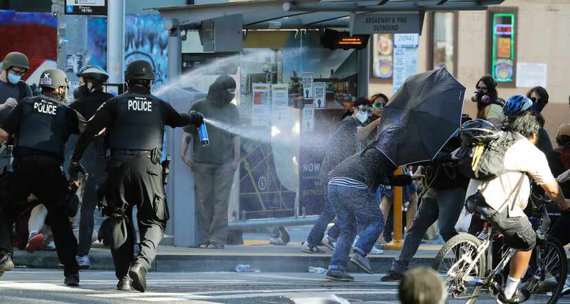 Police in Seattle pepper spray protesters July 25, 2020, near Seattle Central College during...