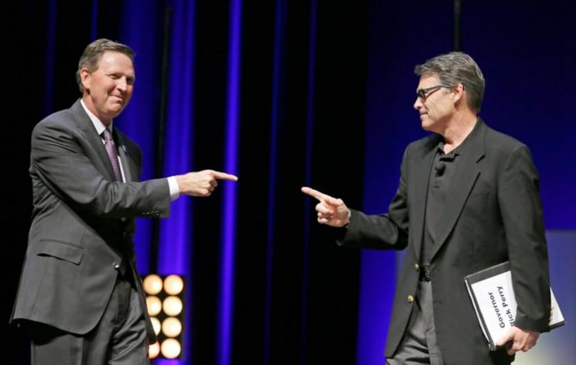 
Rick Perry talks with Bob Vander Plaats, head of the sponsoring group of the summit, who...