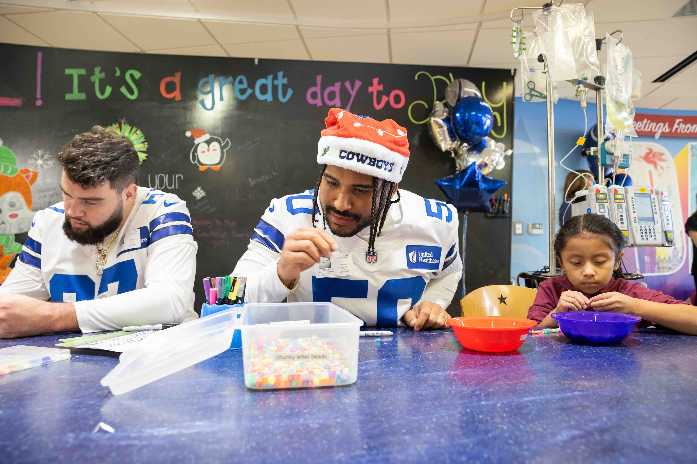 Dallas Cowboys linebacker Eric Kendricks (50) looks closely at a bead while making a...