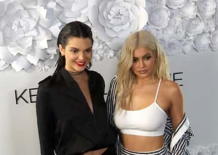 Kendall Jenner (left) and sister Kylie Jenner pose at a party for their KENDALL + KYLIE...