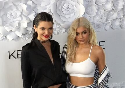 Kendall Jenner (left) and sister Kylie Jenner pose at a party for their KENDALL + KYLIE...