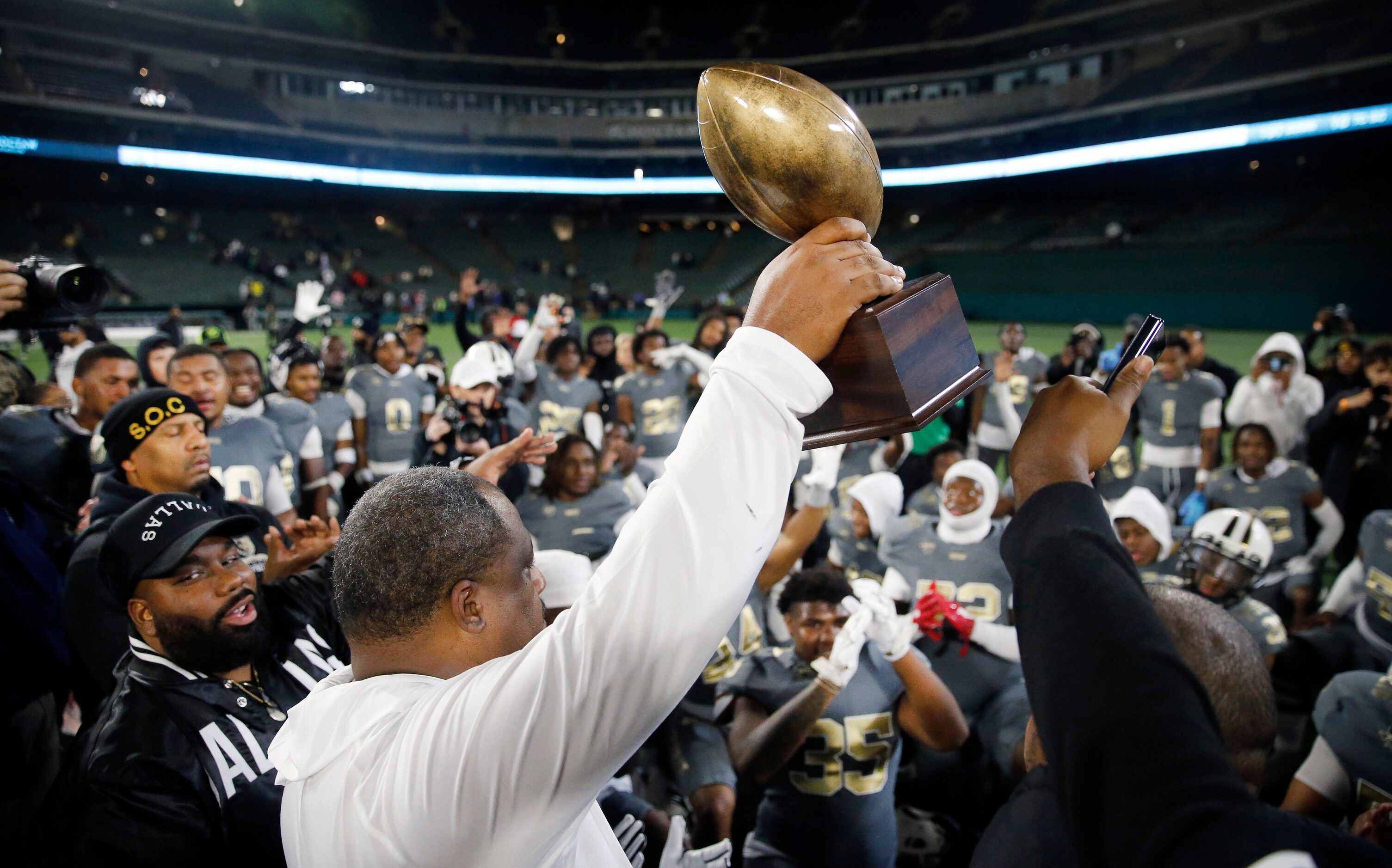 South Oak Cliff  head coach Jason Todd raises the Class 5A Division II Region II final...