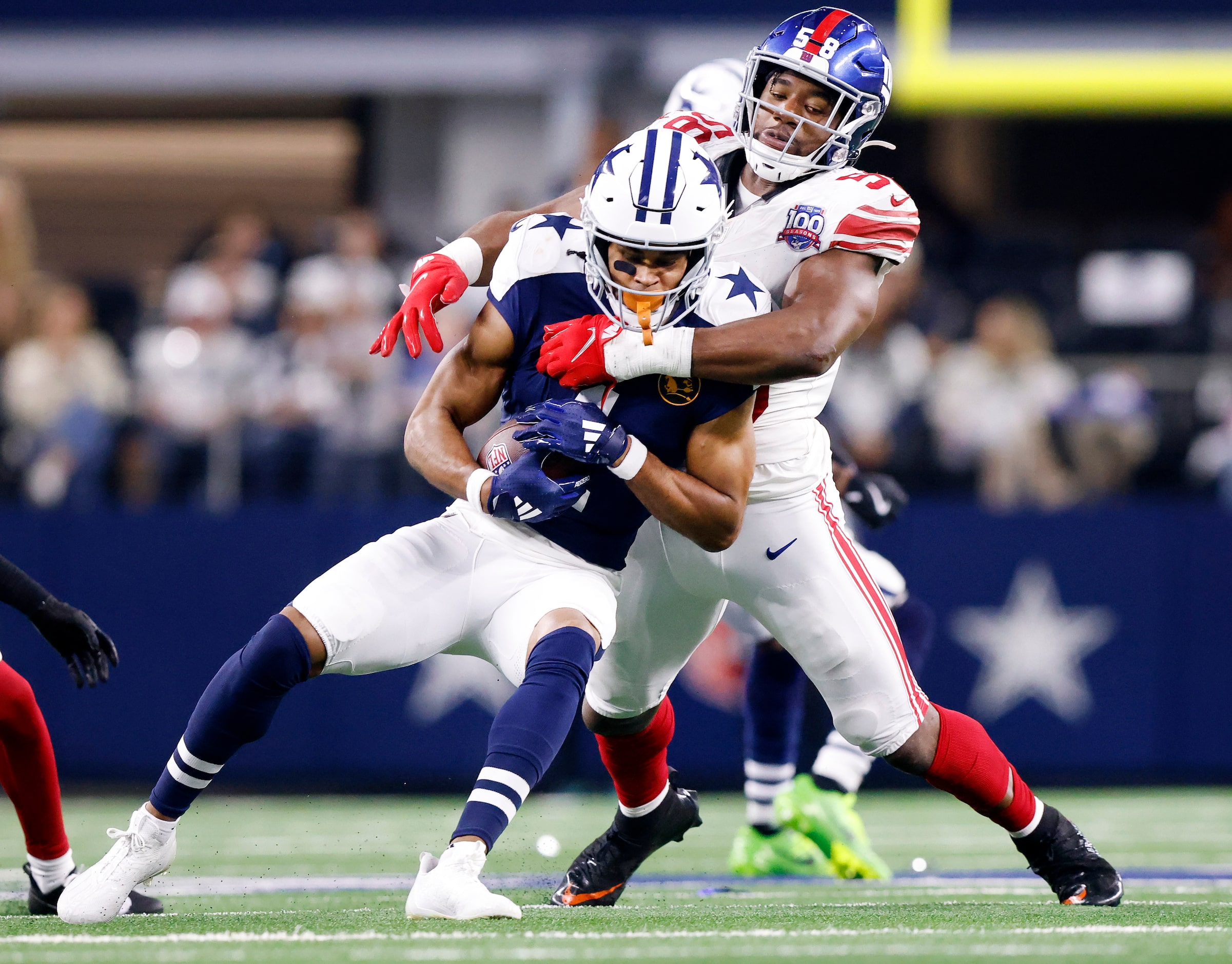 New York Giants linebacker Bobby Okereke (58) wraps up Dallas Cowboys wide receiver Jalen...