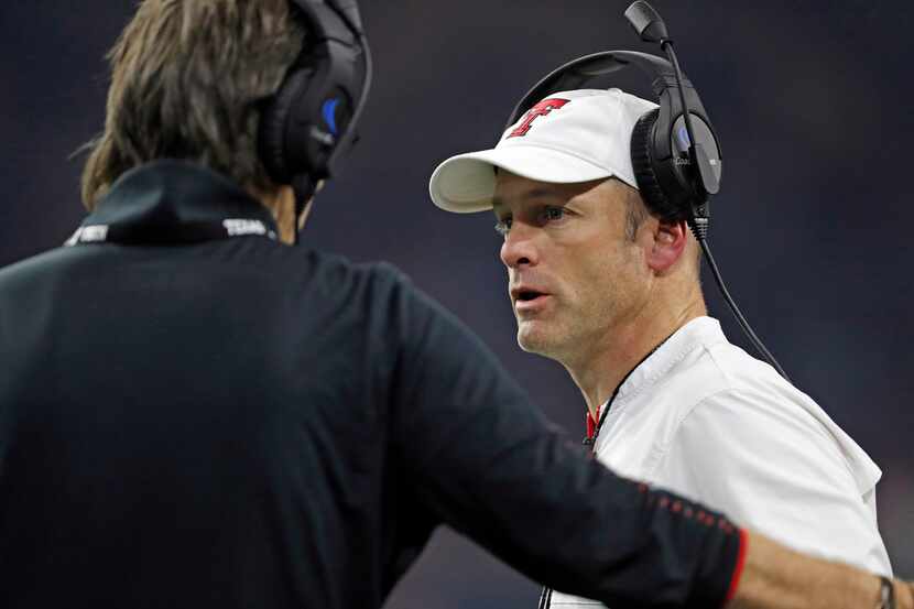 Texas Tech coach Matt Wells, right, talks to special teams coordinator Mark Tommerdahl...