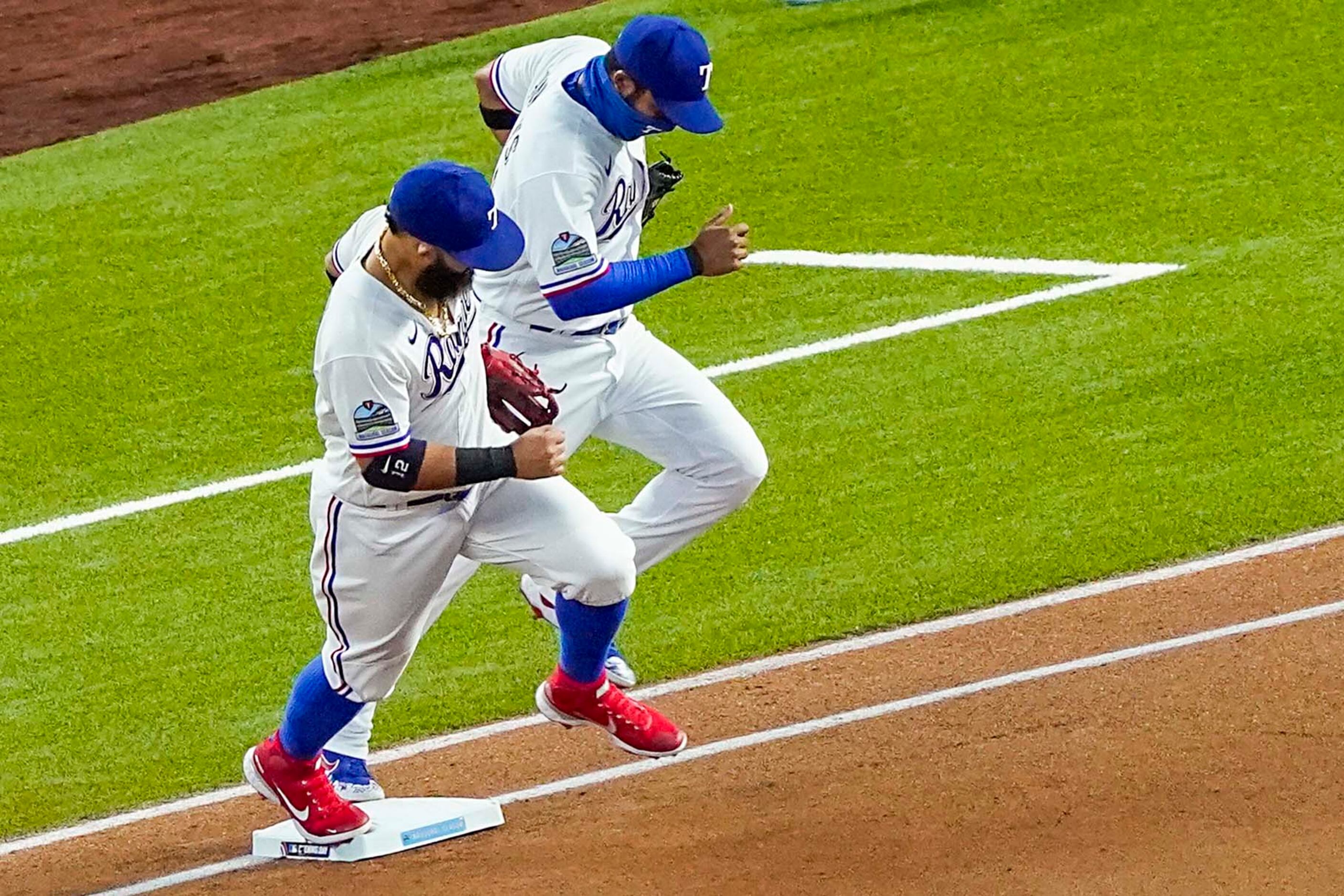 Texas Rangers second baseman Rougned Odor (left) and shortstop Elvis Andrus take the field...