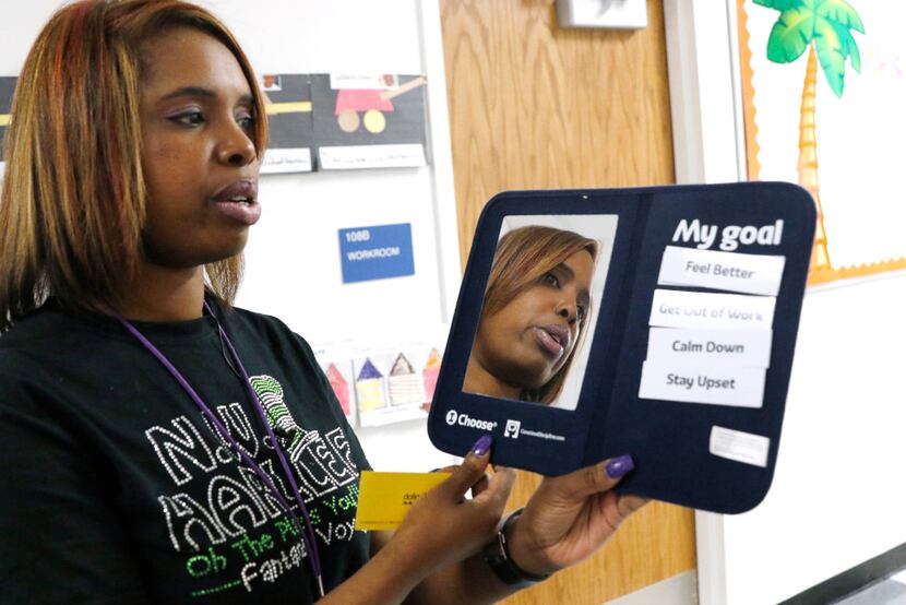 Onjaleke Brown, principal at N.W. Harllee Early Childhood Center in Dallas, holds a...