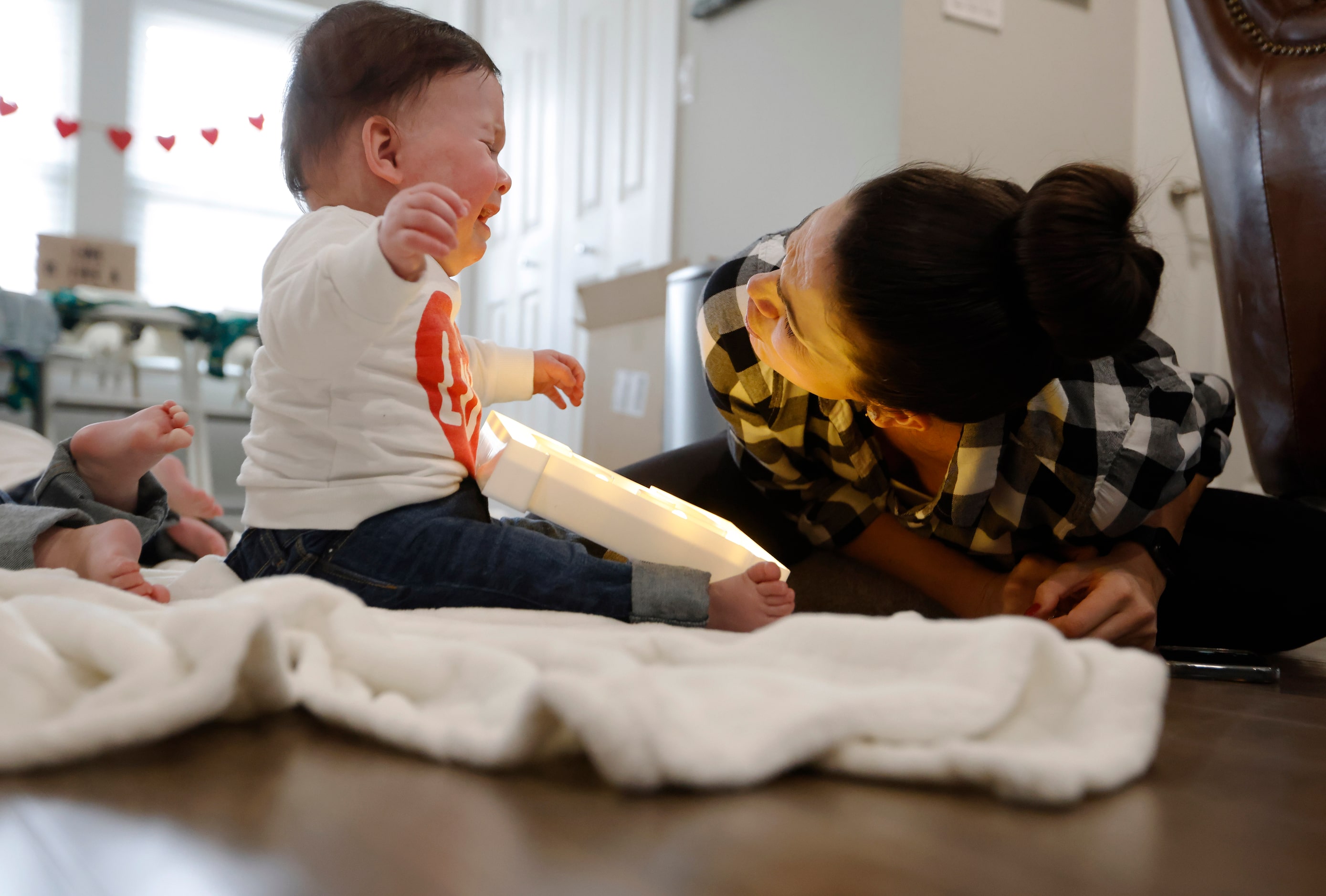 Jenny Marr consoles Hudson Marr as he sits next to the letter "E" during a photo session at...