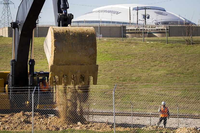
Construction workers do site preparation for expansion at the General Motors Assembly Plant...