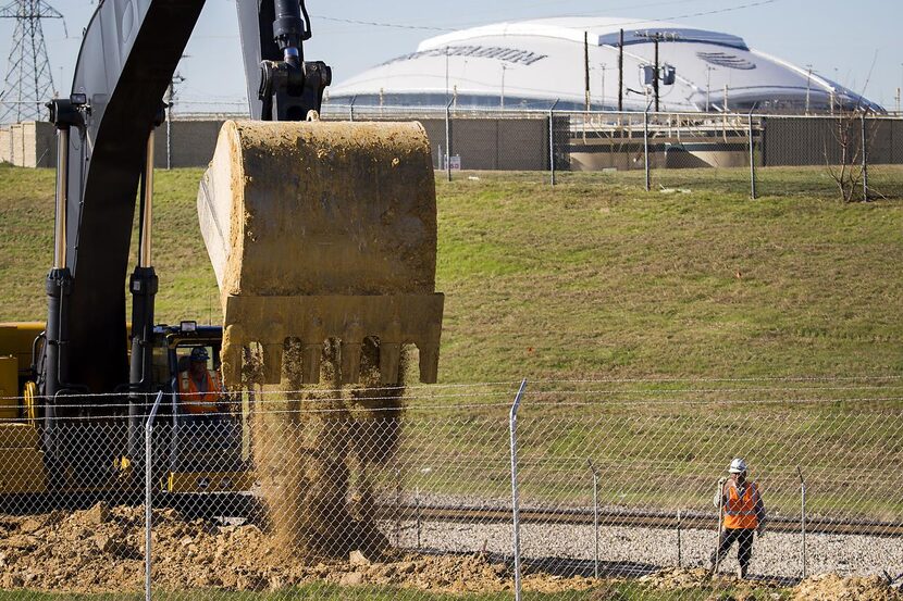 
Construction workers do site preparation for expansion at the General Motors Assembly Plant...