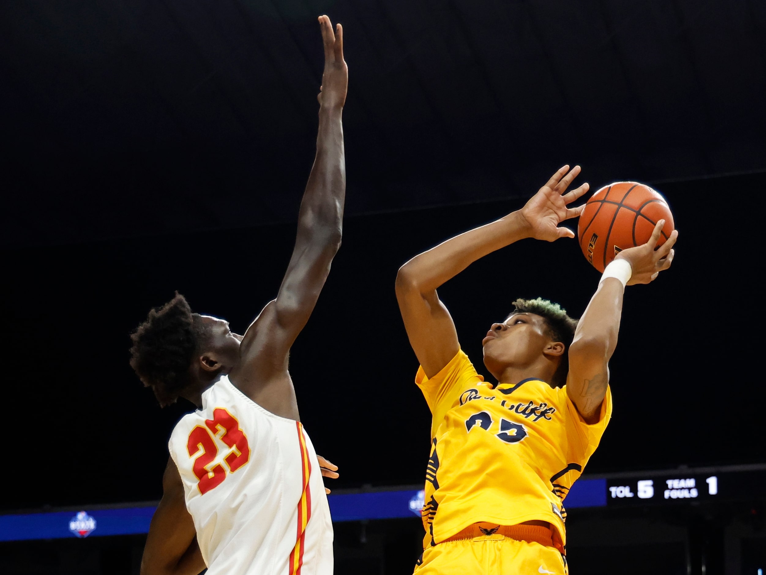 Faith Family's Davion Adkins (25) shoots over Stafford's Dame Salane (23) in the first half...