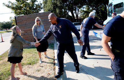 Dallas firefighter Christian Peay thanks Margot O'Daniel, an Executives in Action volunteer,...