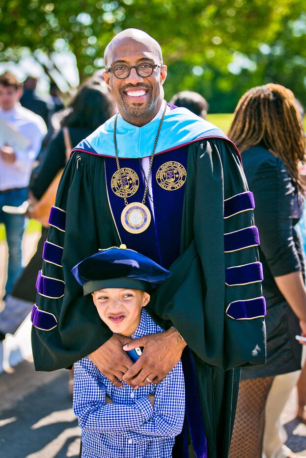 President Michael Sorrell with his son Michael at Paul Quinn College's commencement in...