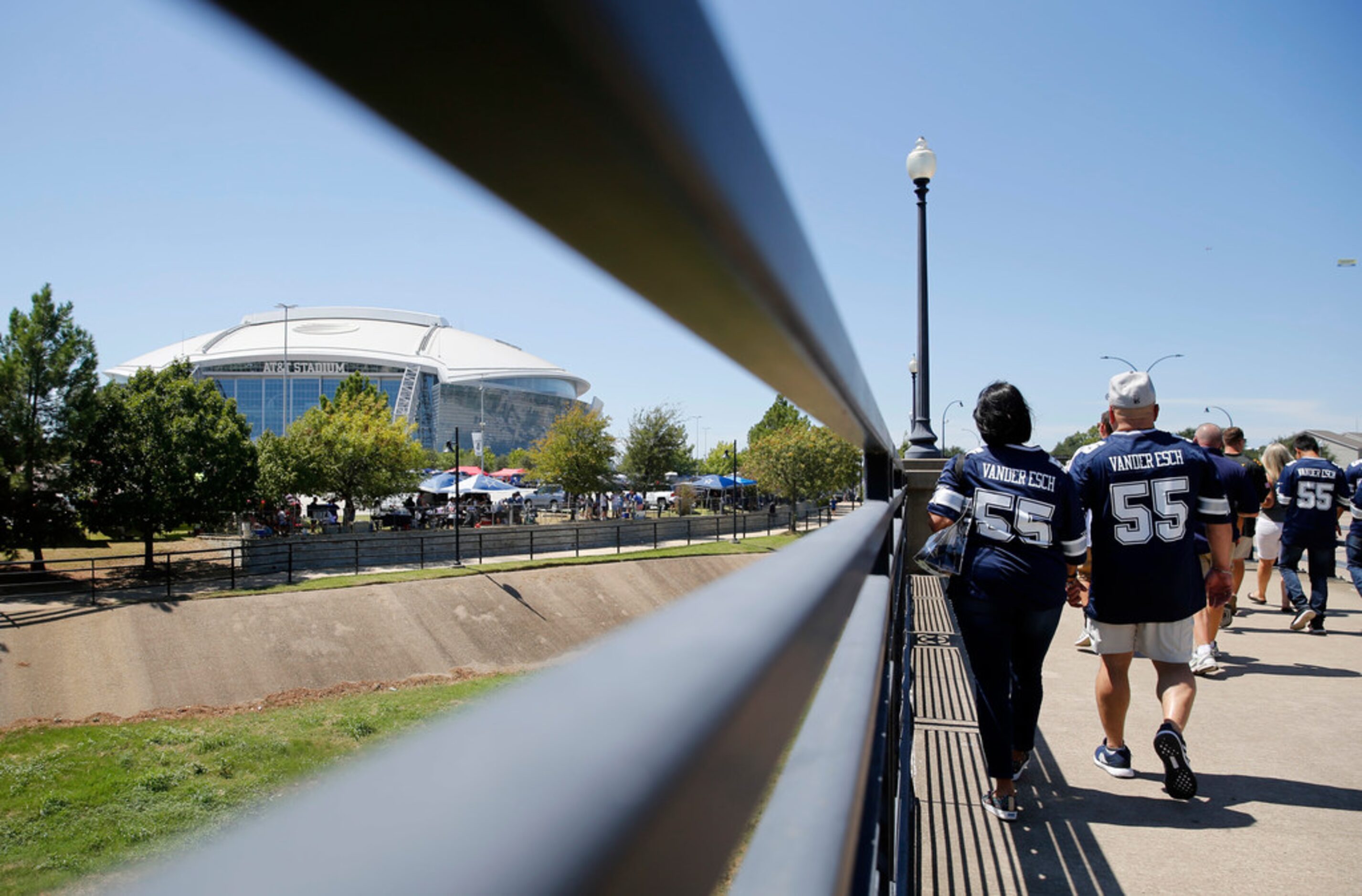 Dallas Cowboys fans make their way to the stadium before the home opener between the Dallas...