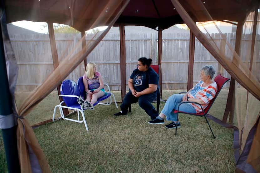 
Shayna Forrest (center), who has a learning disability, enjoys the backyard of the McKinney...