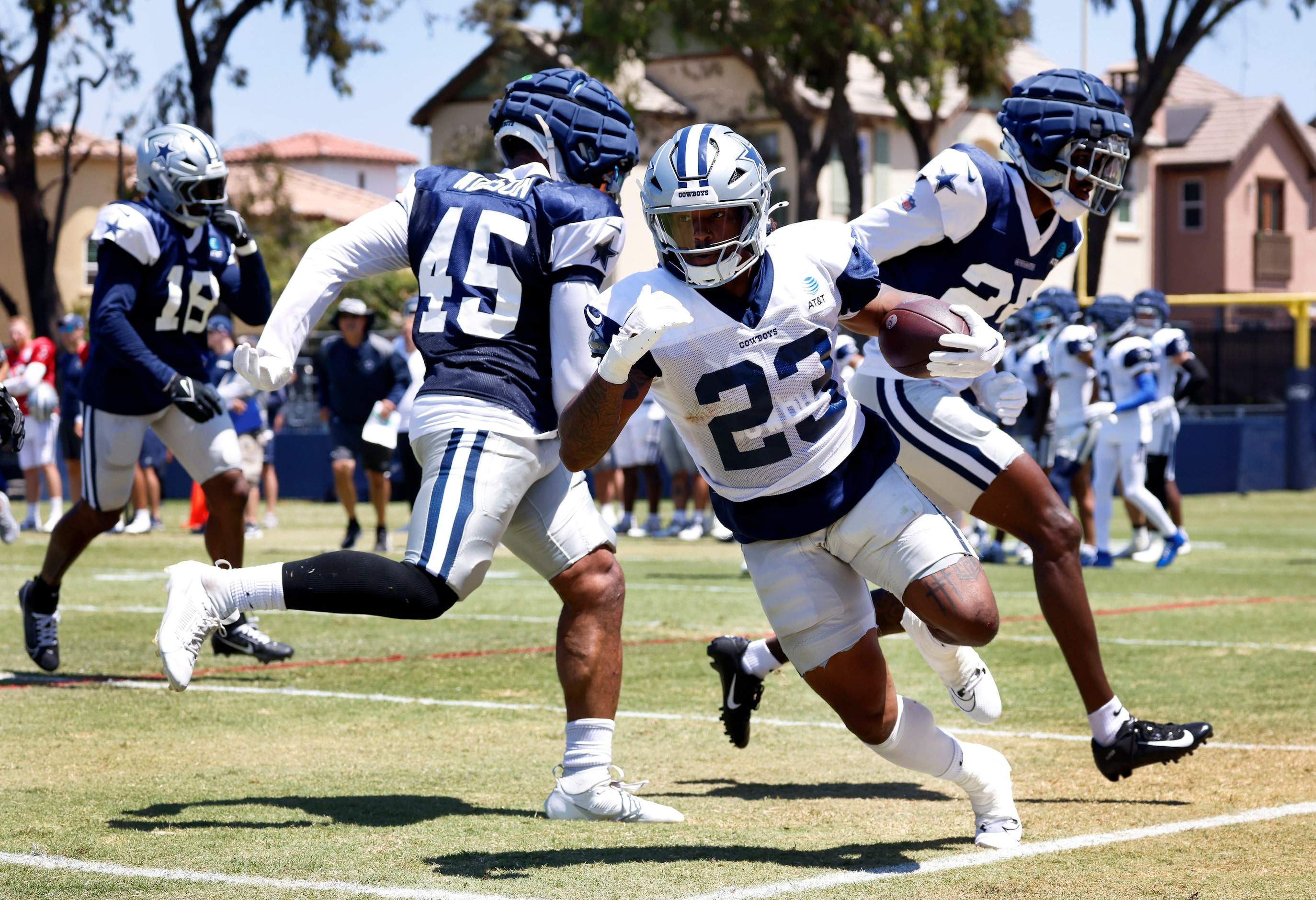 Dallas Cowboys running back Rico Dowdle (23) scoots down the sideline as he’s touched by...