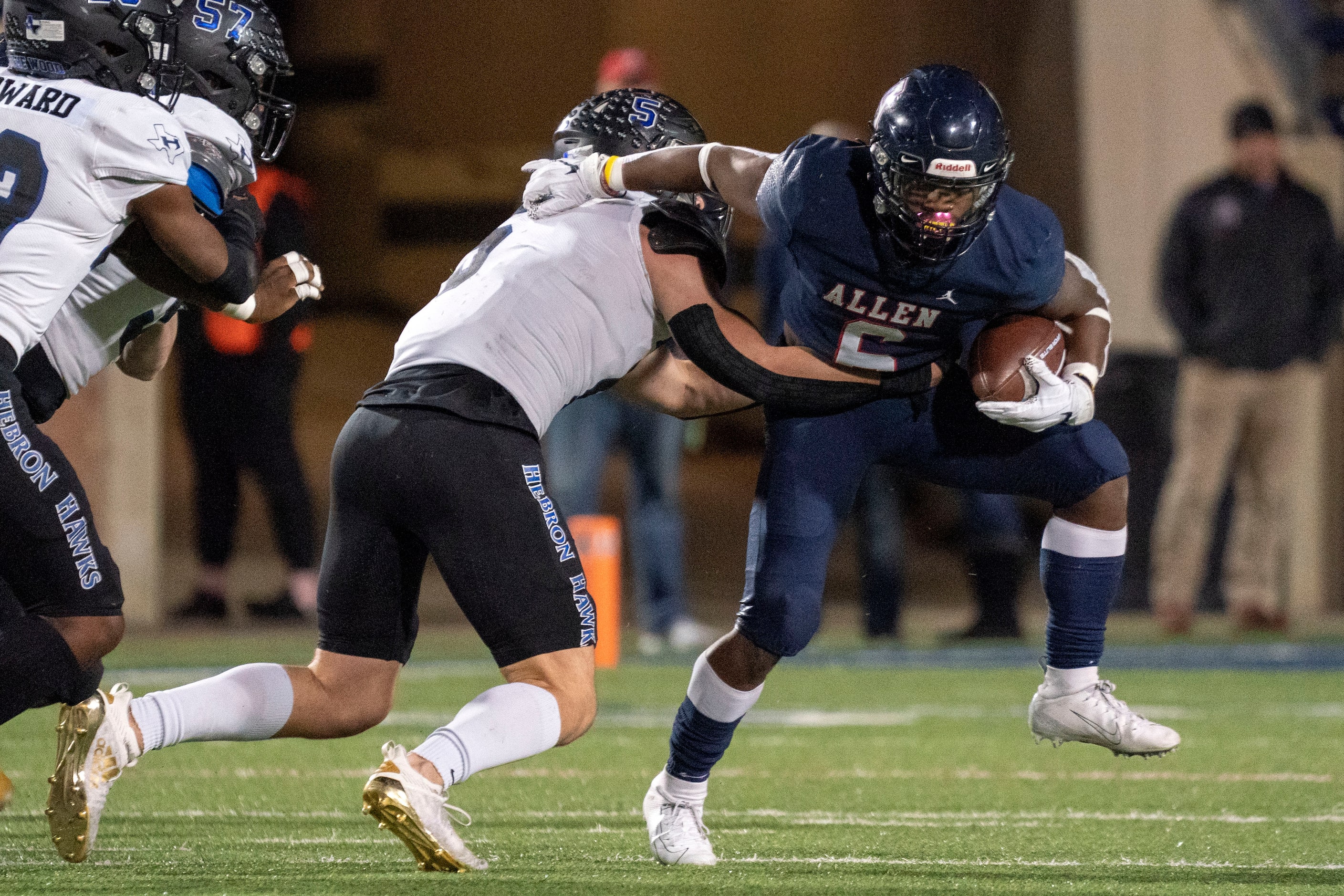 Allen junior running back Devyn D. Turner (6) tries to break the tackle of Hebron linebacker...