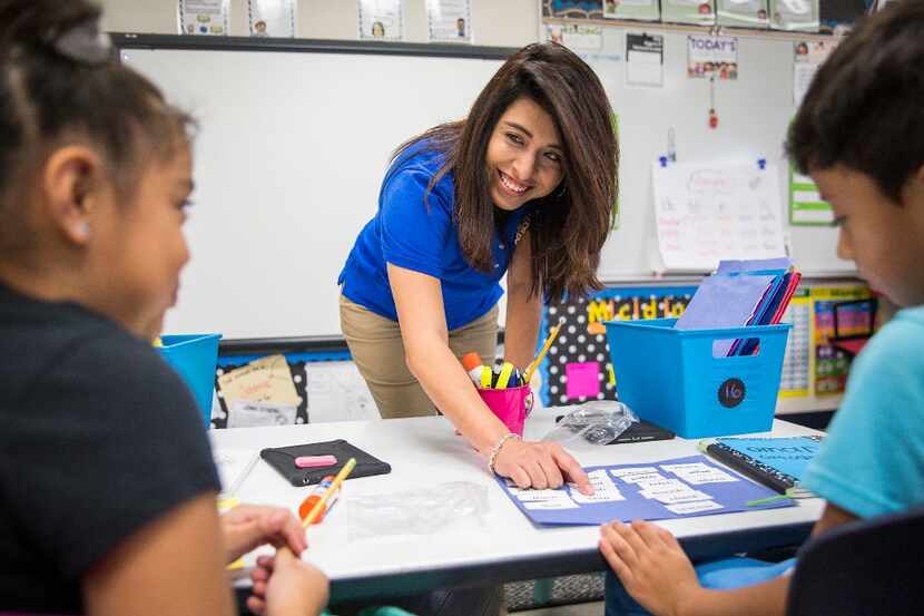 Bilingual teacher Olivia Mendez works with students in her second-grade class at Shands...