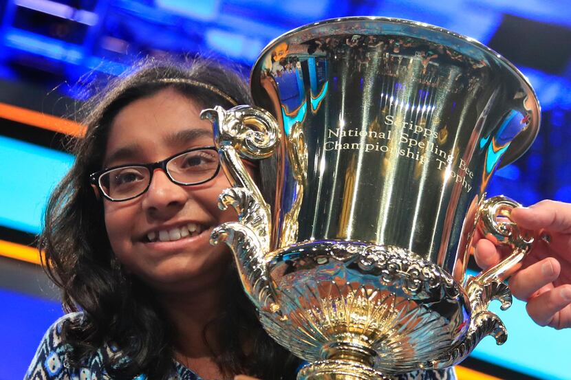 Ananya Vinay, 12, from Fresno, Calif., holds the trophy after being declared the winner of...