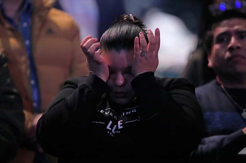 A churchgoer wipes away tears during a service at Lakewood Church Sunday, Feb. 18, 2024, in...