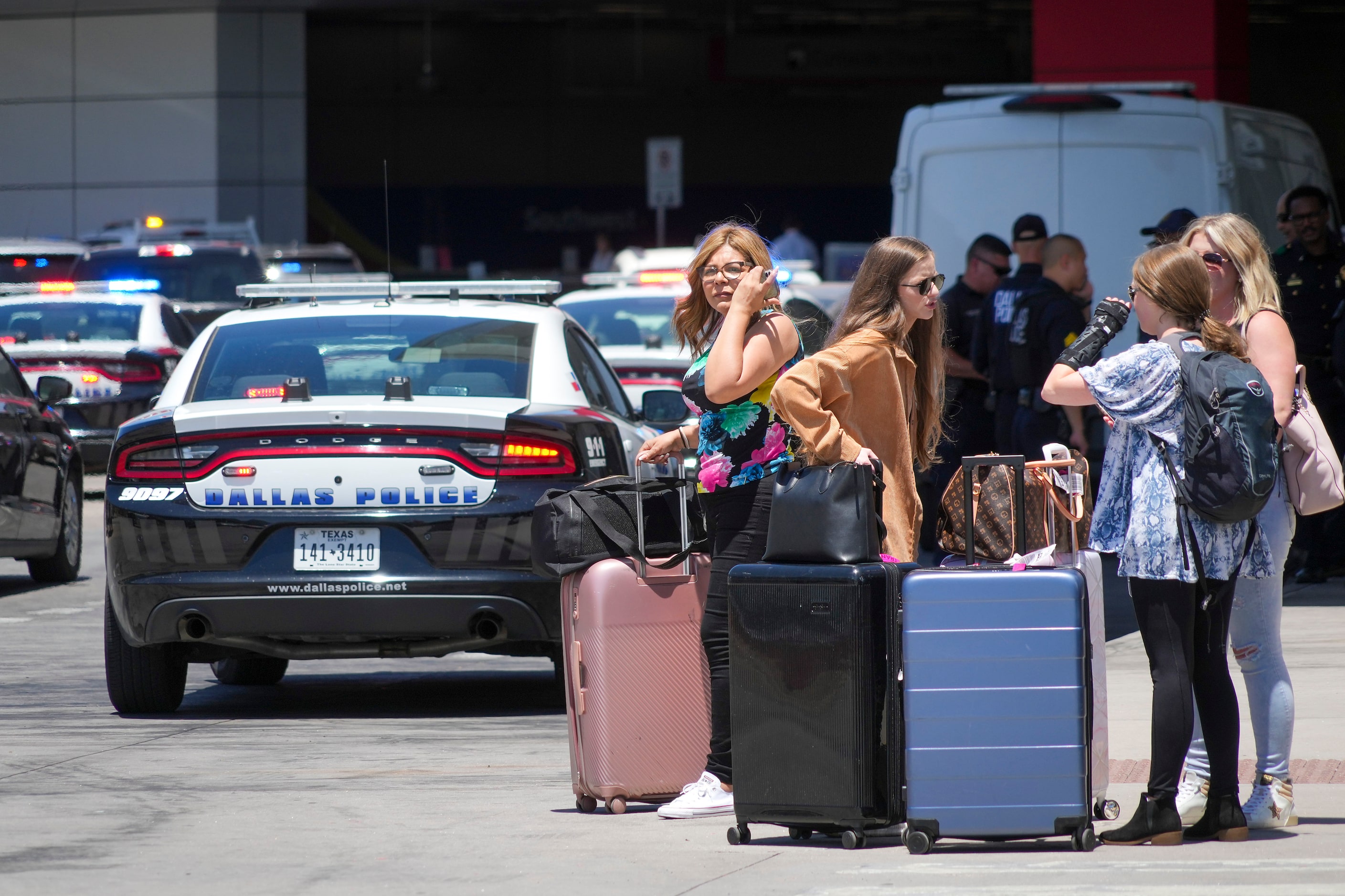 Passengers wait to reenter Dallas Love Field Airport on Monday, July 25, 2022.  A ground...