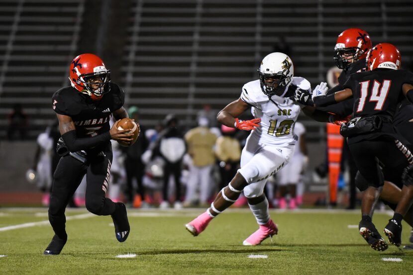 Kimball senior Jerqualan Parks (3) runs away from South Oak Cliff junior Billy Walton (10)...