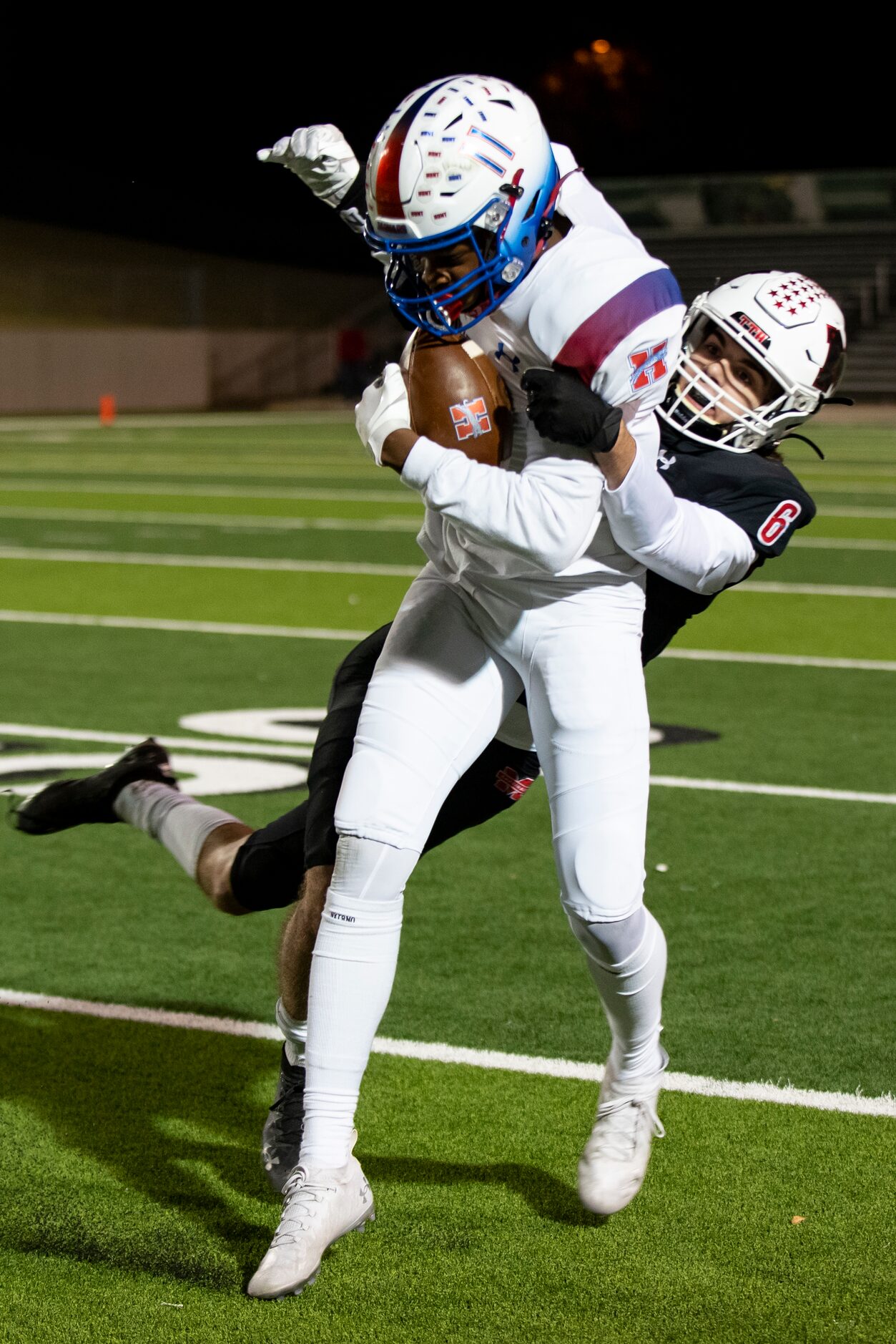 Midlothian Heritage junior Xavier Moten (11) looks to shake Melissa senior Ryan Johnson (6)...