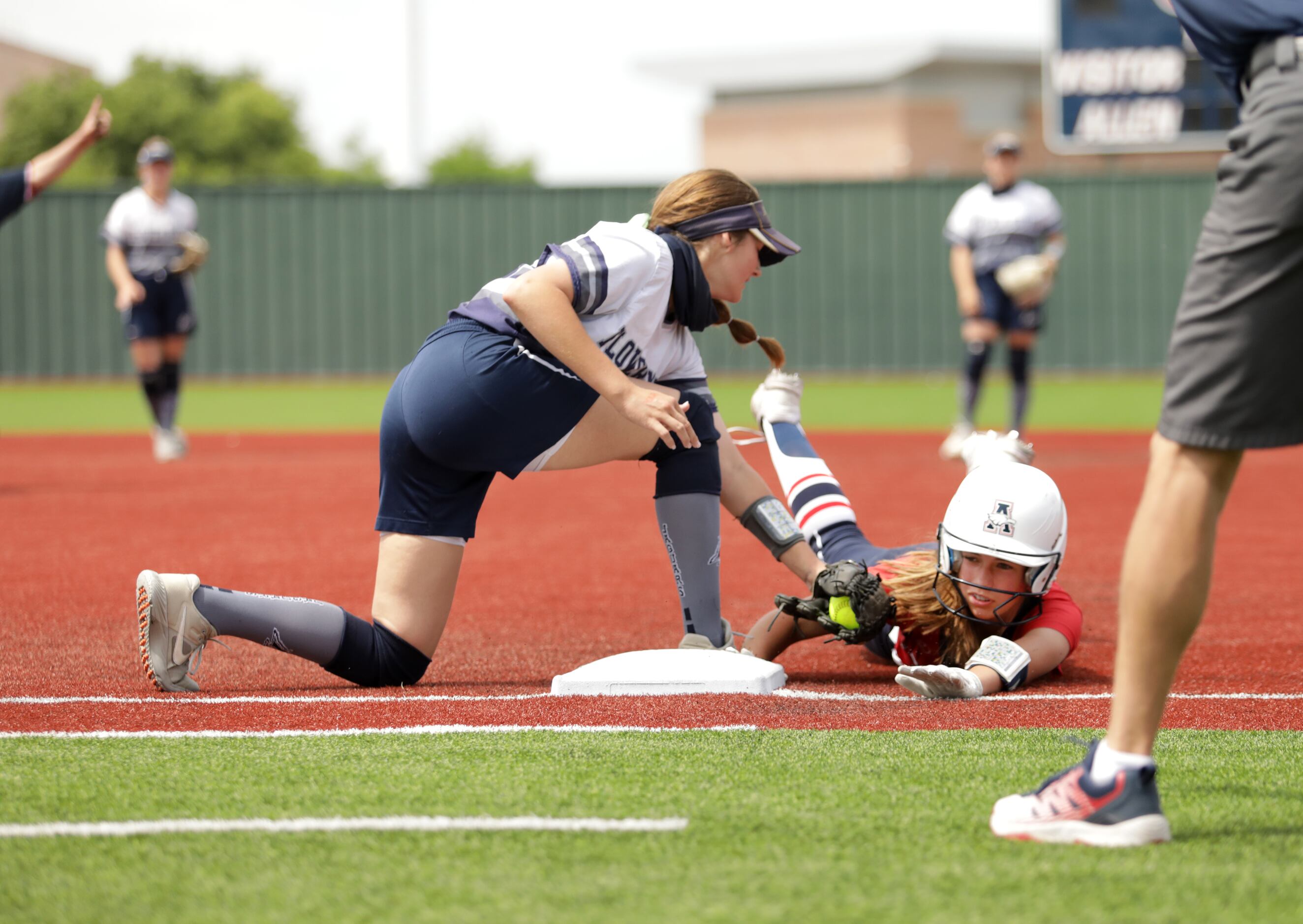 Flower Mound High School player #23, Courtney Cogbill, attempts to tag out Allen High School...